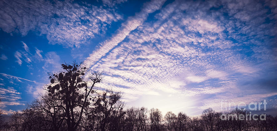 Beautiful altocumulus clouds with sunshine rays and blue sky Photograph by Mendelex Photography