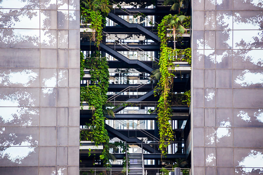 Beautiful architecture building with levels and vegetation growing inside of the building. Photograph by Artur Debat