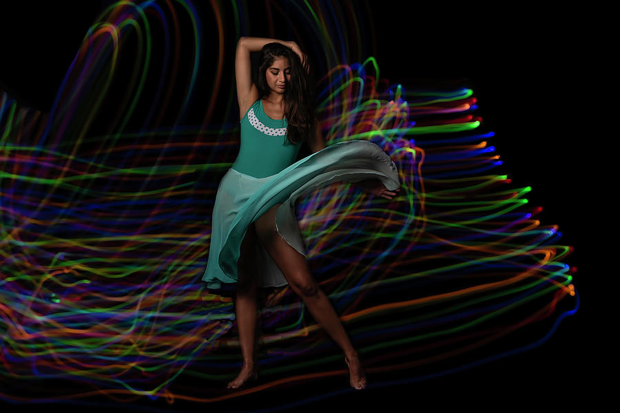 Beautiful dancer in front of light painted background Photograph by Sven Brogren