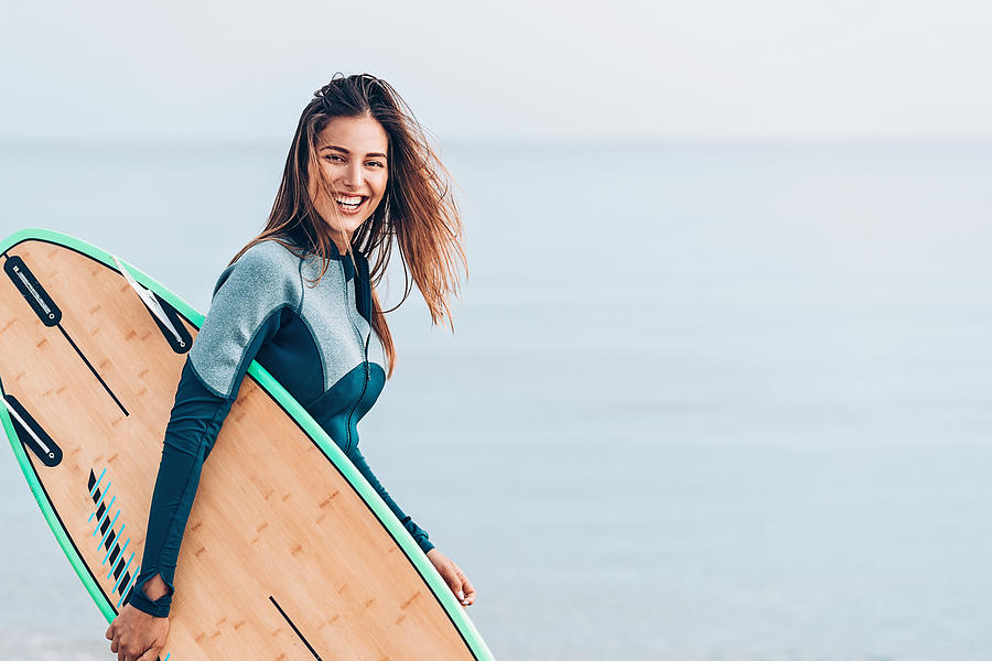 Beautiful female surfer, with copy space Photograph by Pixelfit