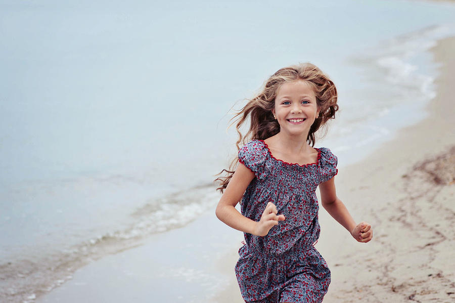 Beautiful girl (6-7) running on beach Photograph by Elitzaguntcheva