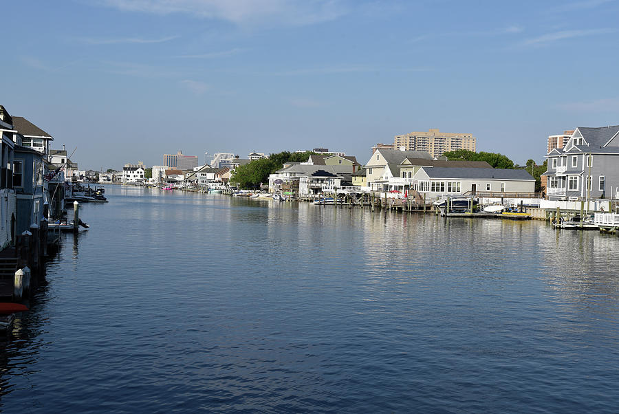 Beautiful homes ad boats line a waterway Photograph by Mark Stout
