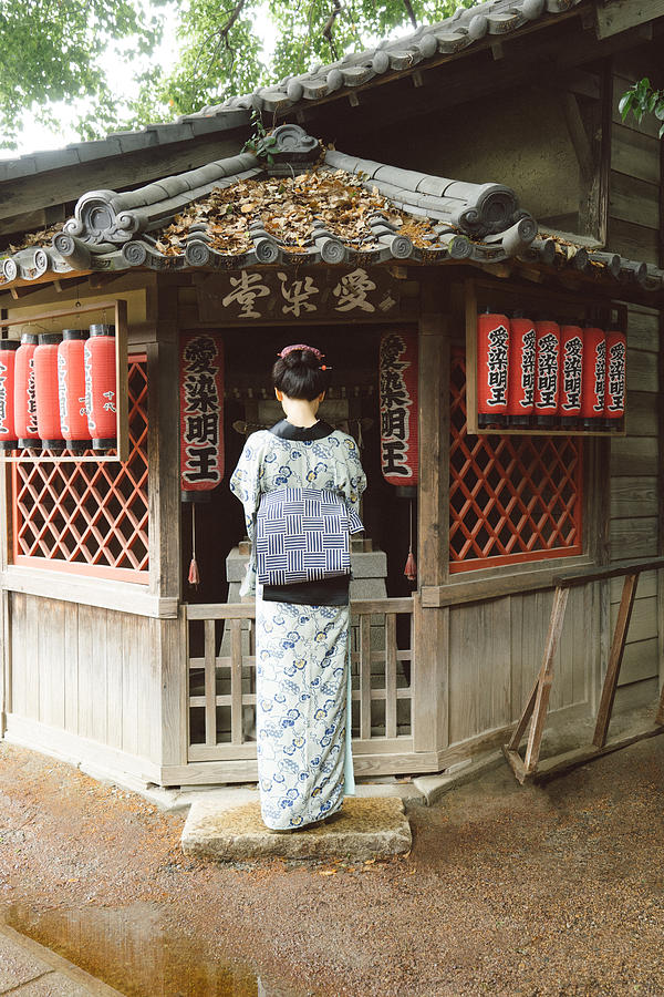 Beautiful Japanese woman wearing kimono praying Photograph by Rossella De Berti