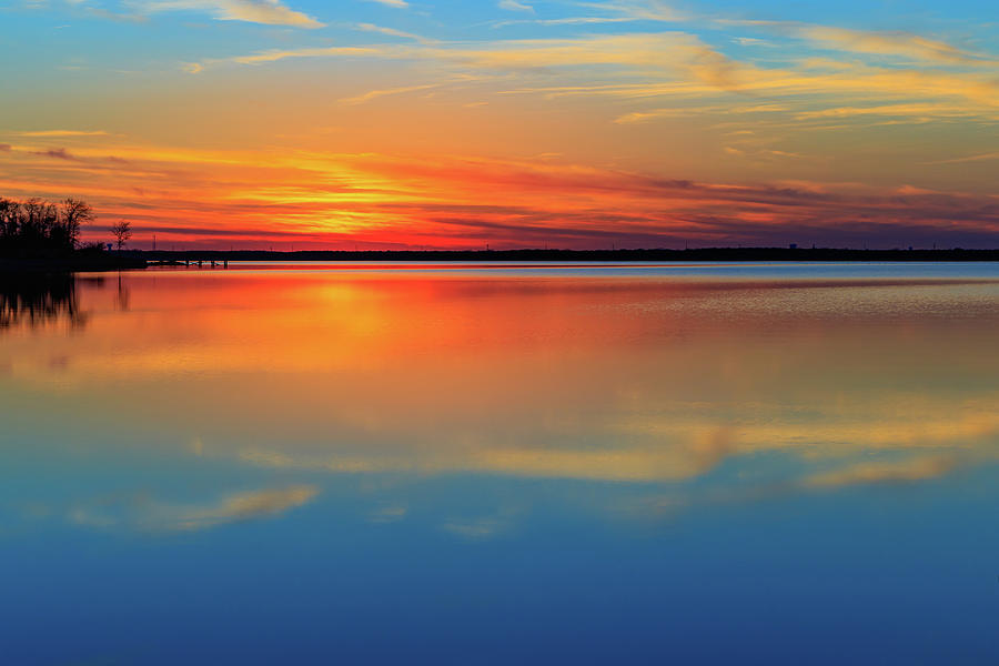 Beautiful lake sunset and its reflection. Very calming. Photograph by David Ilzhoefer