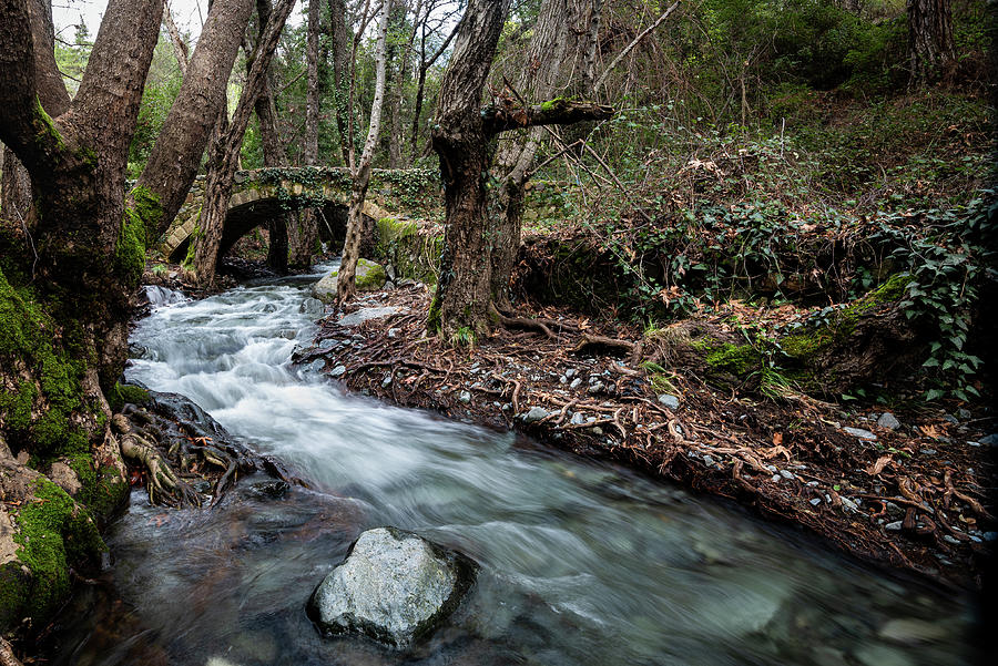Beautiful medieval stoned  bridge with river full with water flo Photograph by Michalakis Ppalis