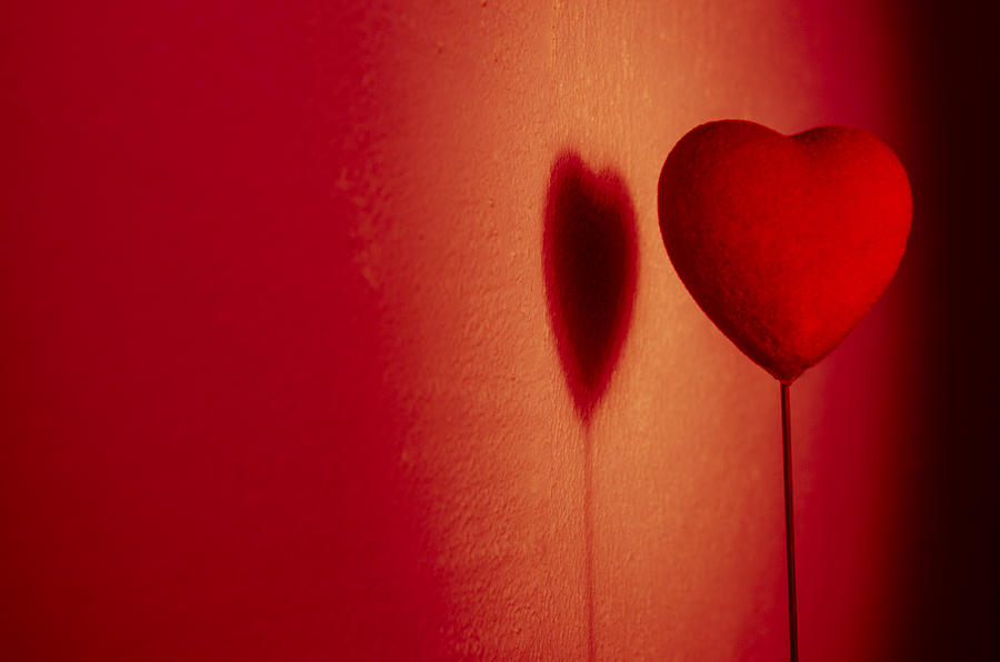 Beautiful red heart play game with a shadow on wall Photograph by Osumposums