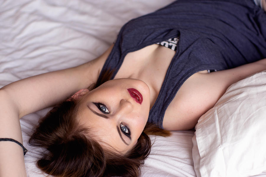 Beautiful Sexy Woman Sitting On The Bed Photograph by Elvira_gumirova