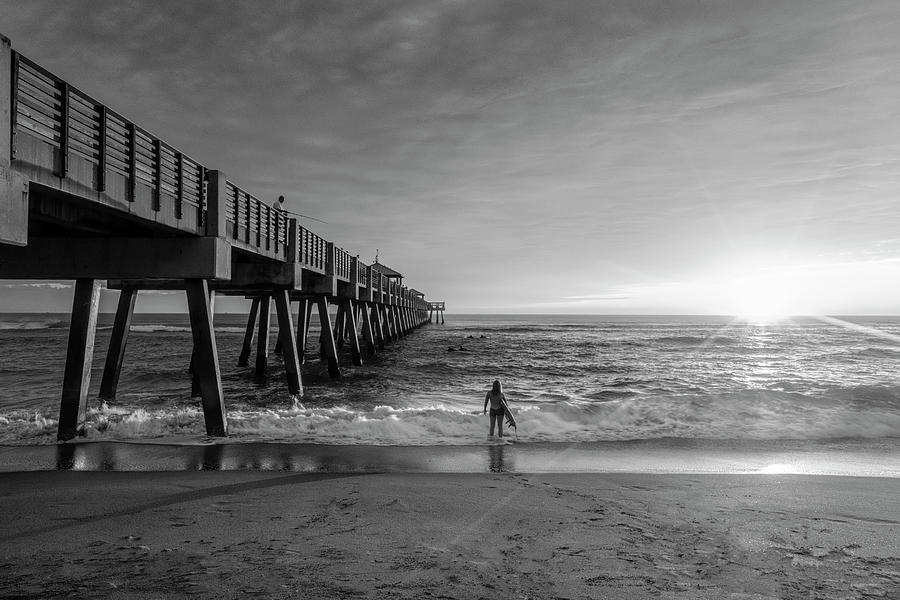 Beautiful Sunrays Surfer at the Pier Black and White Photograph by Debra and Dave Vanderlaan