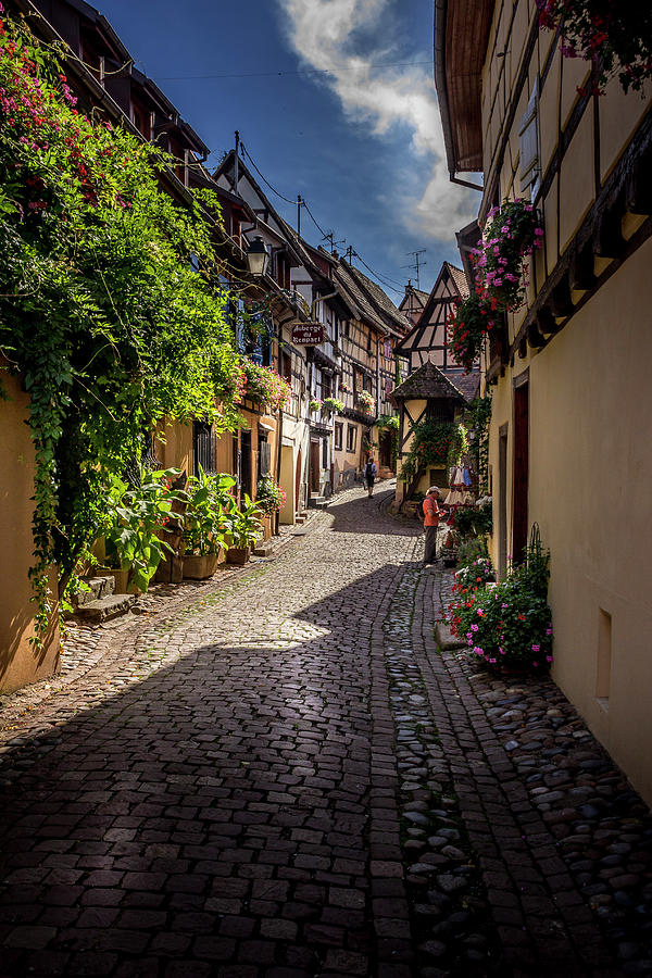 Beautiful view of charming street scene with colorful houses in the historic town of Eguisheim on an idyllic sunny day with blue sky and clouds in summer Photograph by Karlaage Isaksen