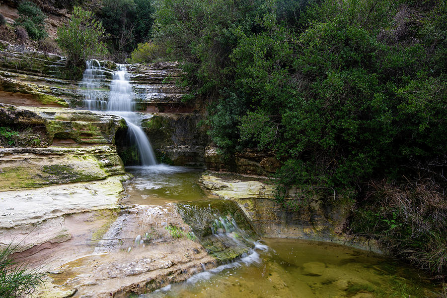 Beautiful waterfall splashing in the canyon creating a small lake Photograph by Michalakis Ppalis