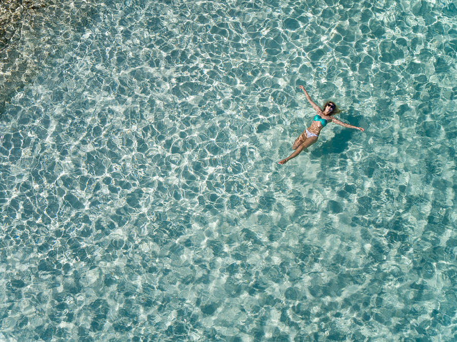 Beautiful Woman Floating In Tropical Water Photograph by Cdwheatley