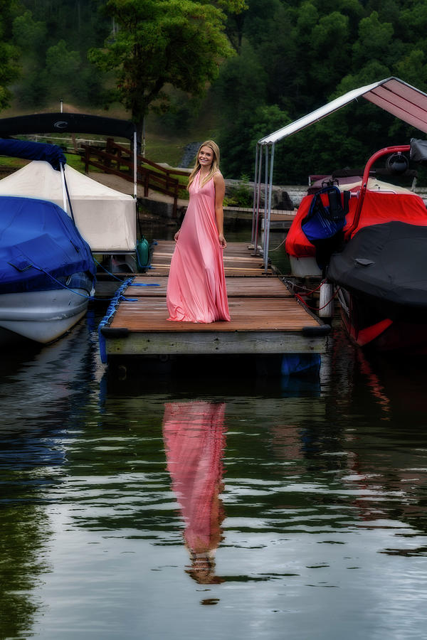 Beautiful woman in pink dress at a marina on a dock Photograph by Dan Friend