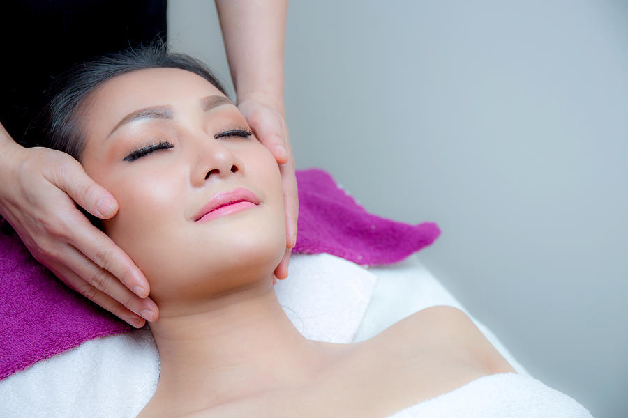 Beautiful woman is getting a facial massage Photograph by Narith_2527