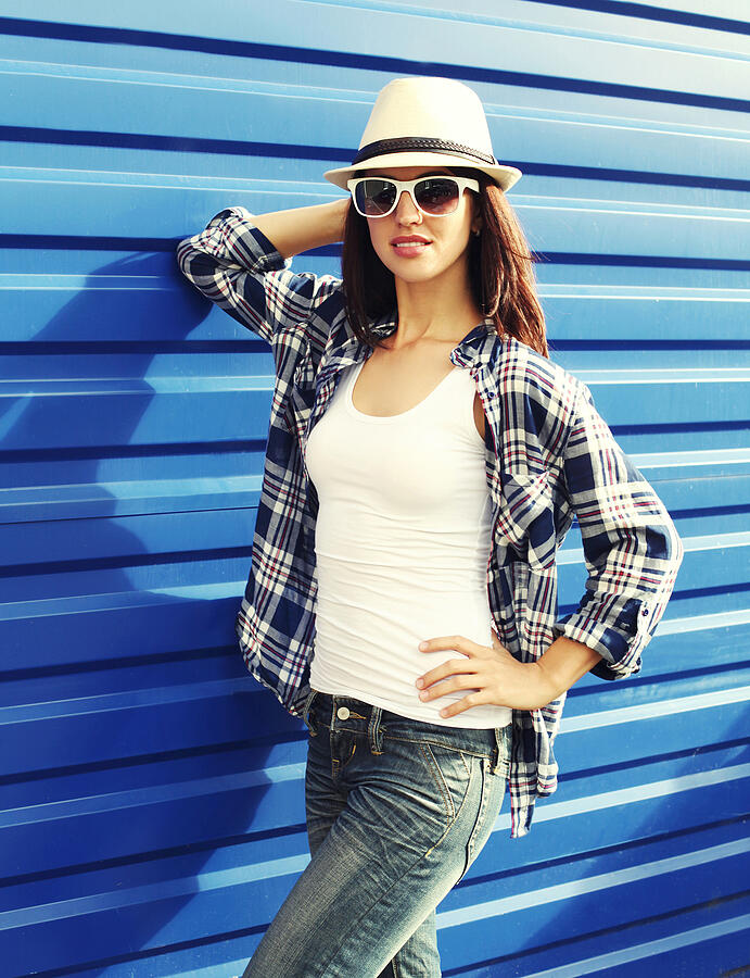 Beautiful woman wearing a straw hat, sunglasses and checkered sh Photograph by Rohappy