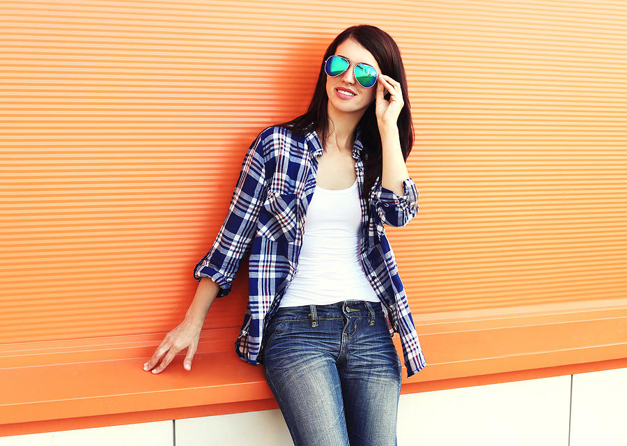 Beautiful woman wearing a sunglasses and checkered shirt over colorful Photograph by Rohappy