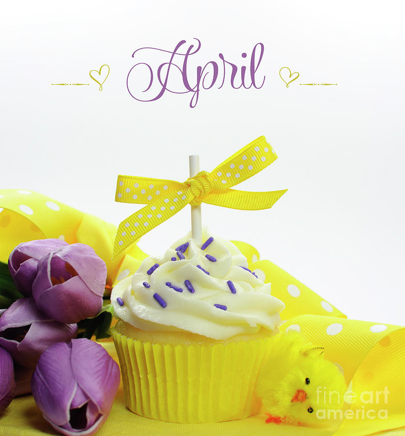 Beautiful yellow Spring or Easter theme cupcake with seasonal flowers tulips Photograph by Milleflore Images