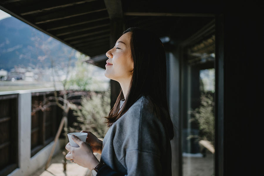Beautiful young Asian woman drinking coffee and enjoying fresh air on balcony in the morning Photograph by D3sign Beautiful young Asian woman drinking coffee and enjoying fresh air on balcony in the morning Photograph by D3sign