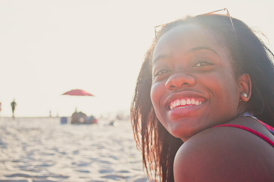Beautiful young black woman smiling. Photograph by Fran Polito