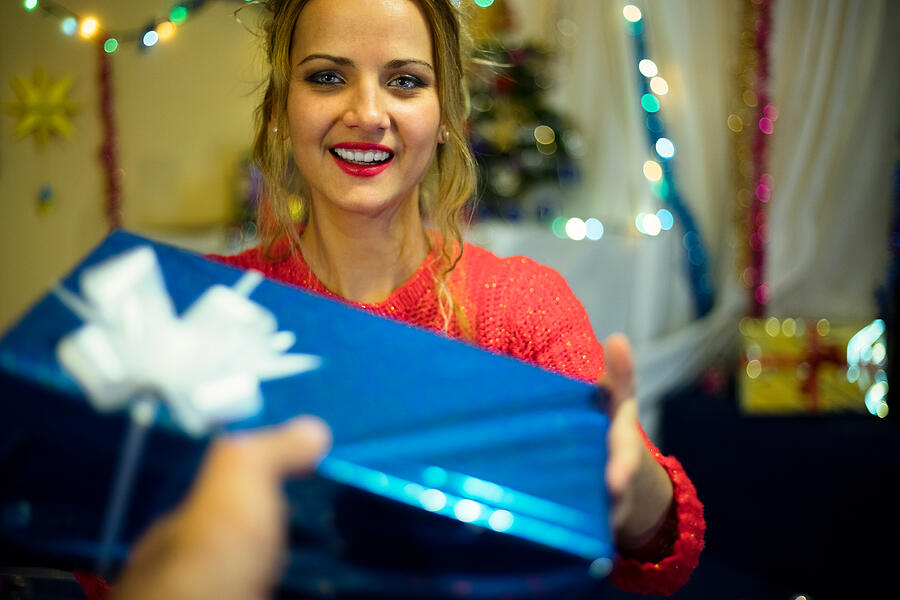 Beautiful young Christmas girl with gift. Happy New Year. Photograph by Viktor Cvetkovic