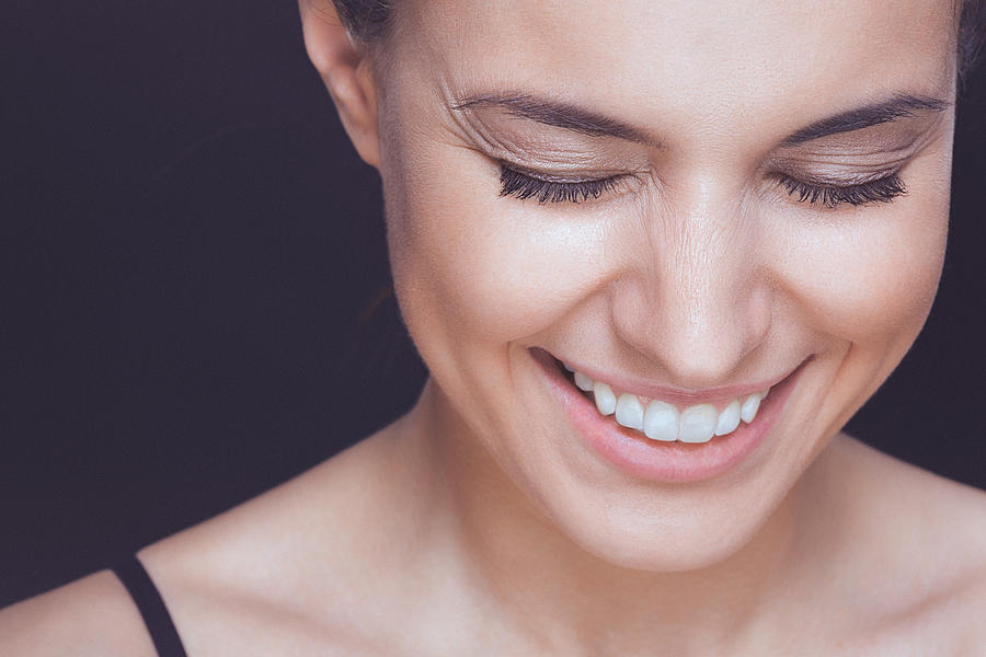 Beautiful young smiling woman with visible wrinkles around her eyes Photograph by Gruizza