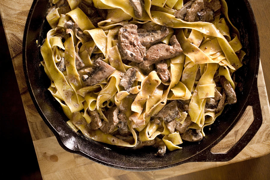 Beef stroganoff in a bowl on a wooden counter Photograph by Lara Hata
