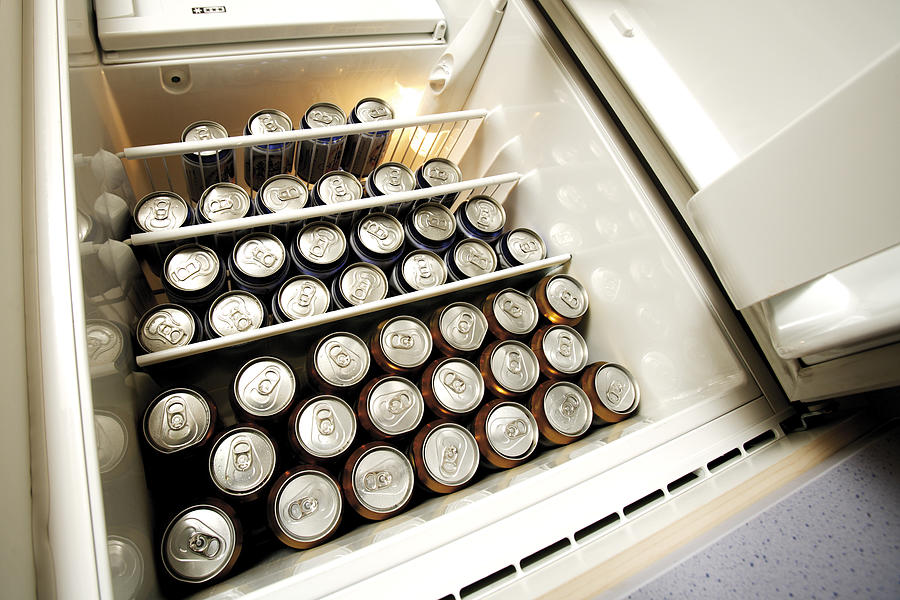 Beer Cans in fridge, low angle view Photograph by Creativ Studio Heinemann