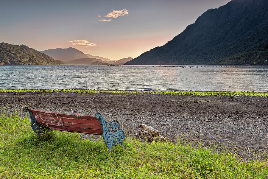 Bench with a peacefull view on the Hornopiren fjord on sunset Photograph by Henri Leduc