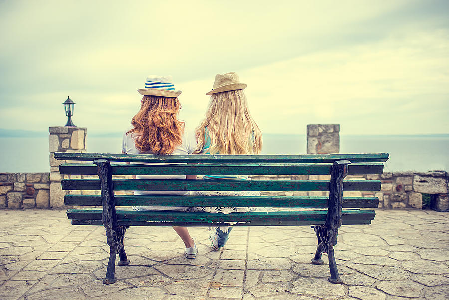 Best friends on bench at the sea Photograph by MilosStankovic