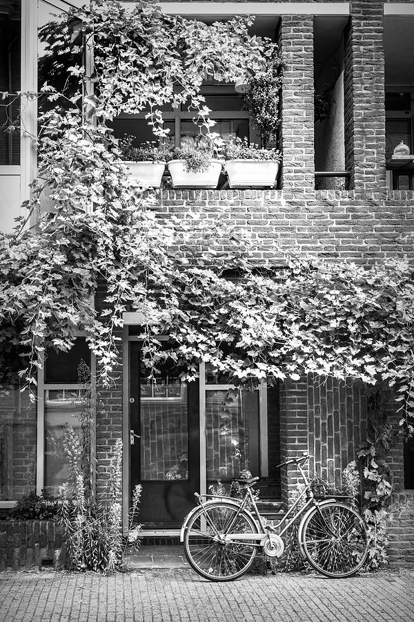 Bicycle Along the Streets of Amsterdam in Black and White Photograph by Debra and Dave Vanderlaan