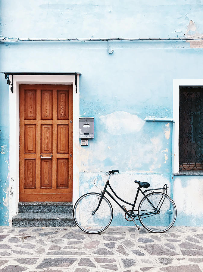 Bicycle parked against blue wall in a village Photograph by Alexander Spatari