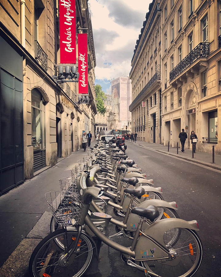 Bicycle sharing system bikes parked on Paris street, France Photograph by Anouchka