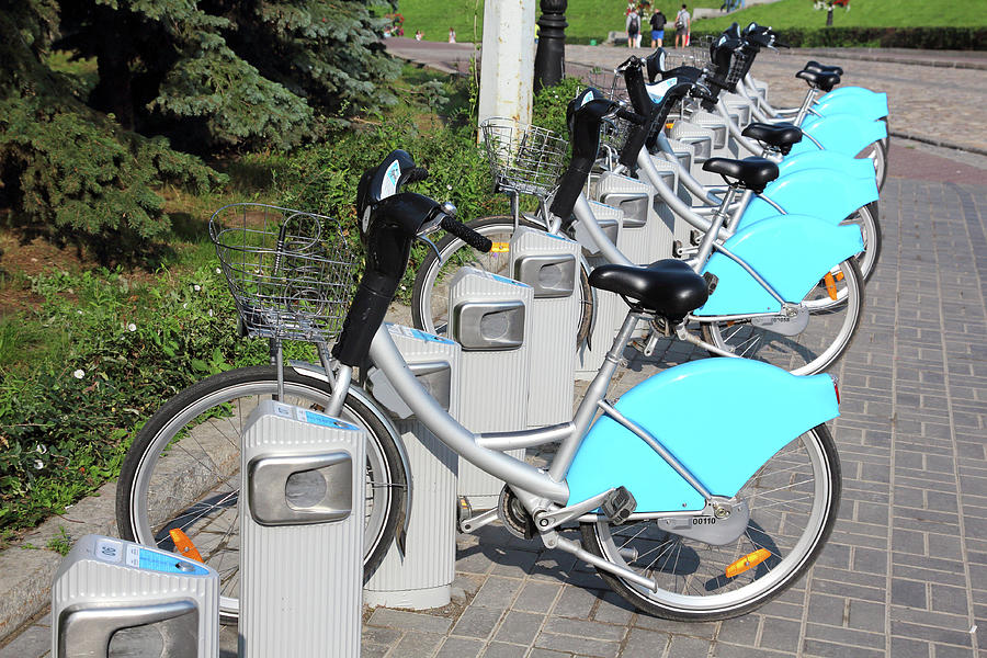Bicycles In Row On Parking For Rental Photograph by Mikhail Kokhanchikov