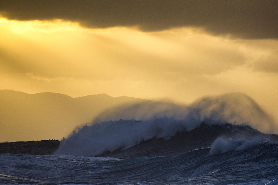 Big wave crashing with spray blowing up at sunset Photograph by Santiago Urquijo