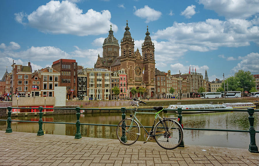 Bike on Amsterdam Canal with Basilica of St. Nicholas Photograph by Darryl Brooks