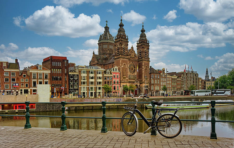 Bike on Amsterdam Canal with Basilica of St. Nicholas in Background Photograph by Darryl Brooks