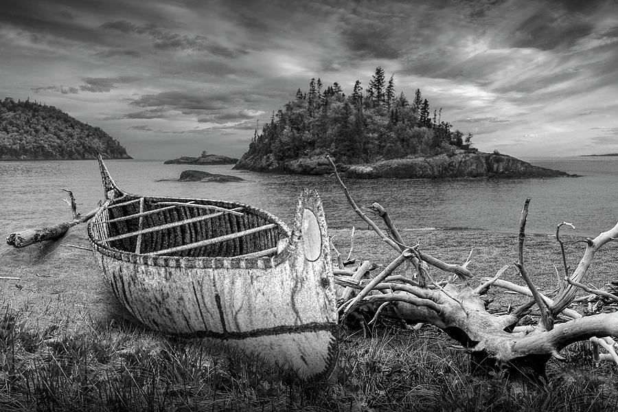 Birch Bark Canoe ashore on Driftwood Beach in Black and White Photograph by Randall Nyhof