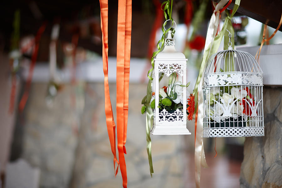 Birdcages decorated with flowers inside, at celebration Photograph by Namiroz