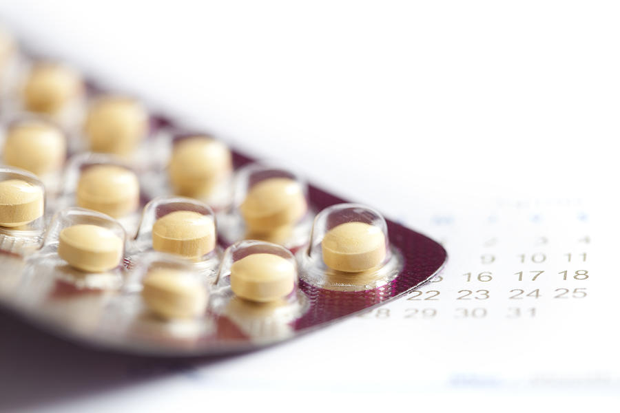 Birth control pills macro with calendar Photograph by MarsBars
