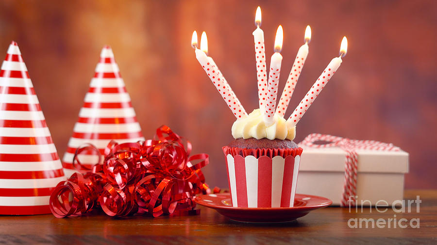 Birthday cupcake with candles and gift Photograph by Milleflore Images