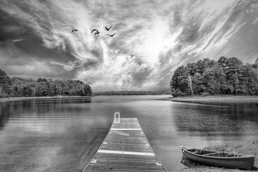 Black and White Canoe at the Lake Dock Photograph by Debra and Dave Vanderlaan