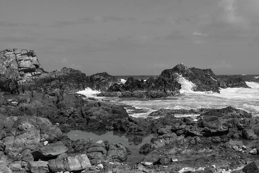 Black And White Photograph - Black and White Image of the Rocky Ocean Coast of the Aruba National Park by Alisha Watson