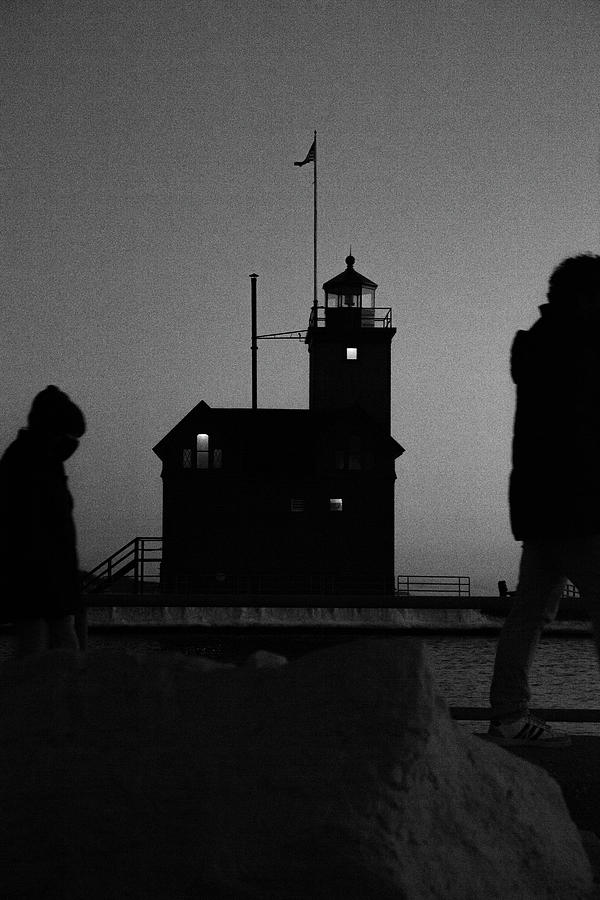 Black and white of father and child walking past the Holland Michigan Lighthouse Photograph by Eldon McGraw