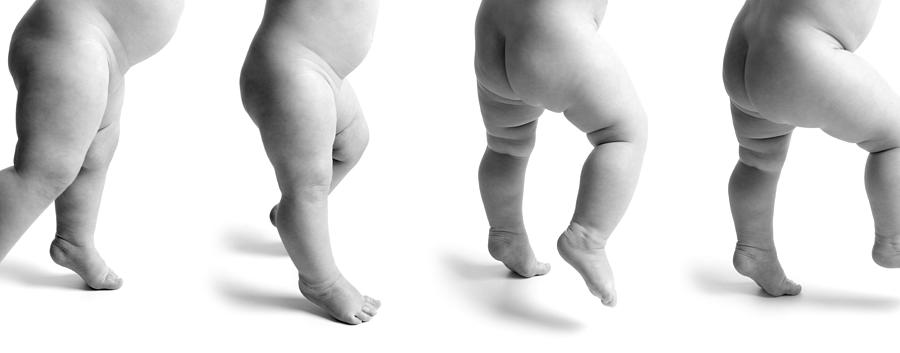 Black And White Photo Of A Naked Baby Trying To Learn To Walk Photograph by Photodisc