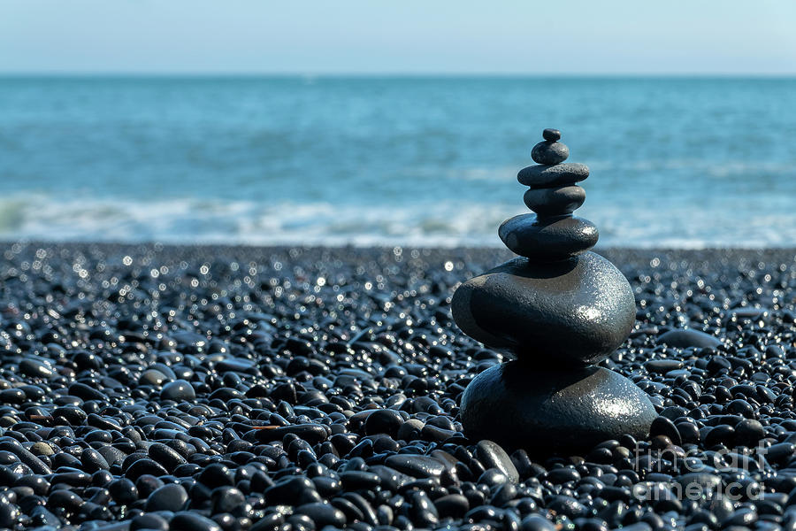 Black beach balanced stones Photograph by Delphimages Photo Creations