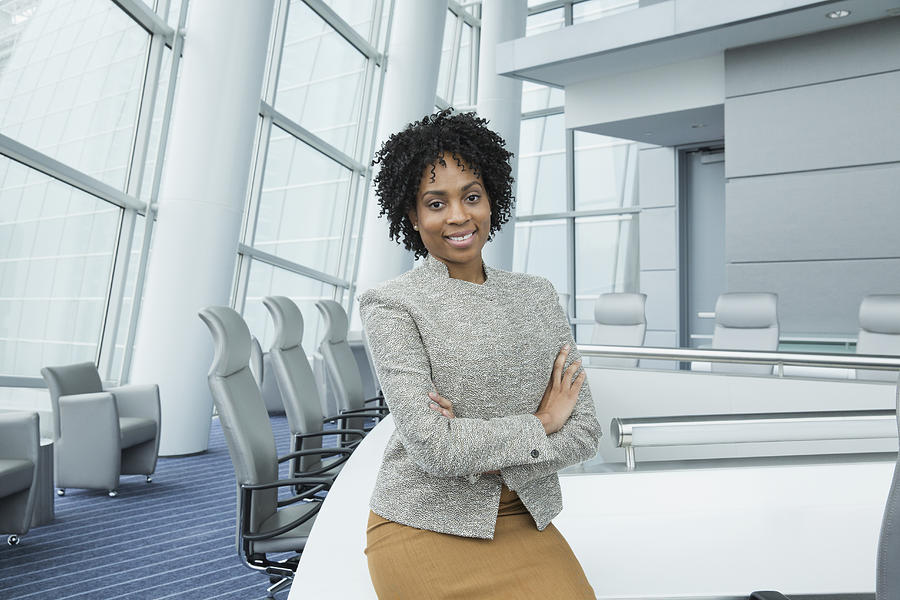 Black businesswoman standing in conference room Photograph by Ariel Skelley