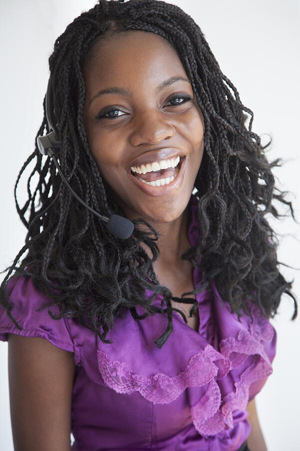 Black businesswoman talking on headset Photograph by Peter Dressel