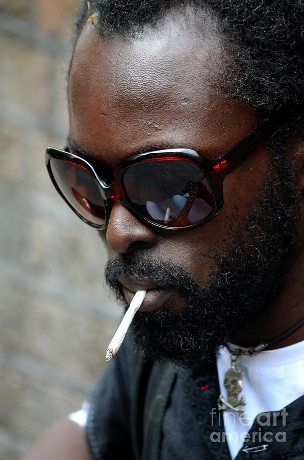 Black busker with sunglasses and cigarette and skull pendant London England Photograph by Imran Ahmed