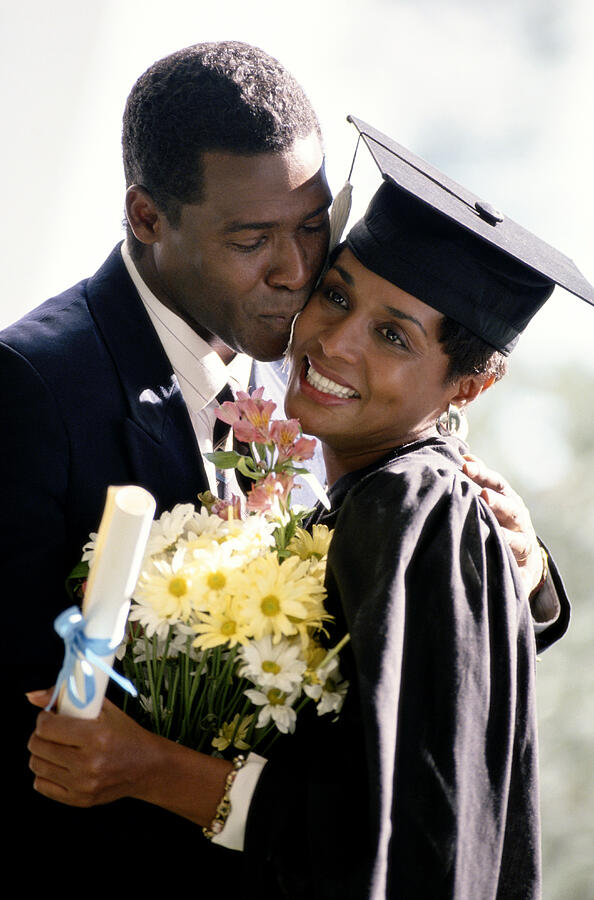 Black Couple At Womans Graduation Photograph by Yellow Dog Productions