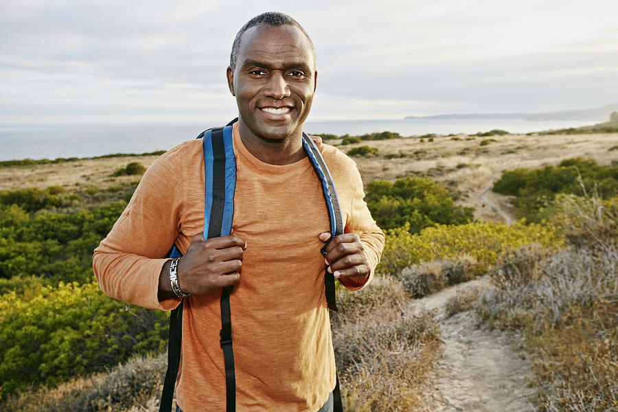 Black man hiking on rural path Photograph by Peathegee Inc
