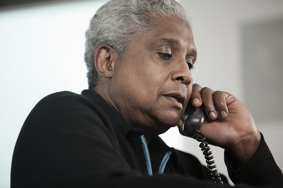 Black man talking on telephone Photograph by Hill Street Studios
